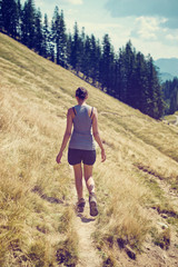 Young female hiker walking along a trail