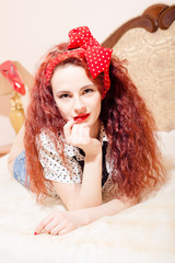 Amazing young woman with long wavy red hair