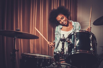 Black woman drummer in a recording studio