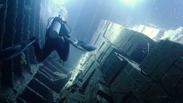 Diver moves along the wreck