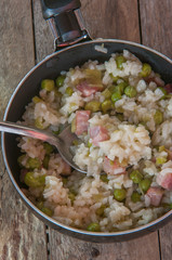 Lemon risotto with bacon and peas top view