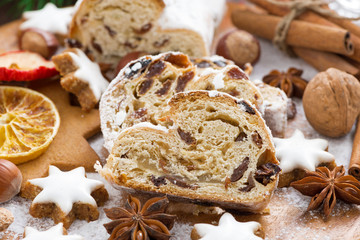Fototapeta premium Christmas Stollen with dried fruit, assorted cookies and spices