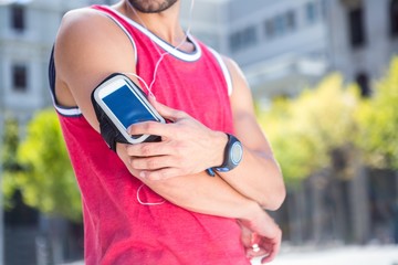 Handsome athlete adjusting his armband