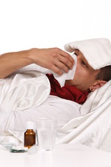 Obraz na płótnie Canvas Sick man. Flu. Caught Cold. Sneezing into Tissue. Headache. Virus .Medicines