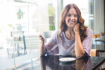 Pretty brunette enjoying a coffee