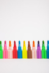Multicolored crayons on a white paper background.