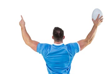 Rugby player cheering with the ball