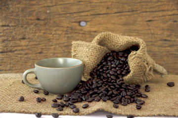 Fototapeta na wymiar Stock Photo:.Cup full of coffee beans on the cloth sack