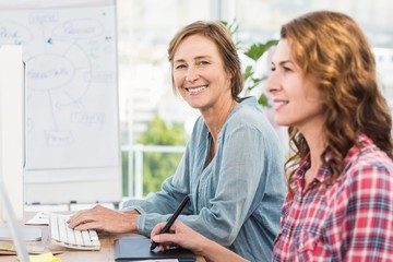 Casual businesswomen looking at computer