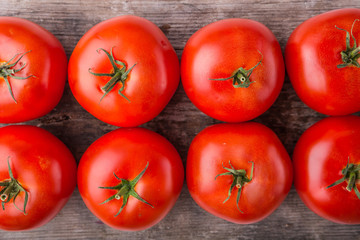 Ripe tomatoes on wood background
