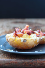 Closeup of cheese and bacon baked potato.