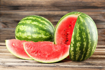 Tasty watermelon on brown wooden background