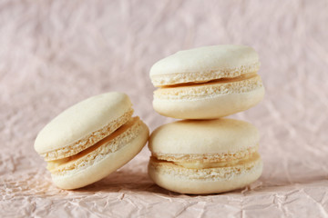 Beige macarons on paper background