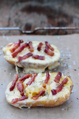 Closeup of cheese and bacon baked potatoes.