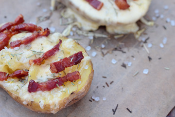 Closeup of cheese and bacon baked potatoes.