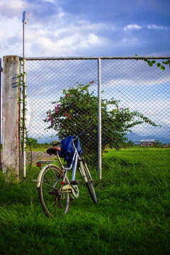 Old bicycle front of Maesot airport fence.