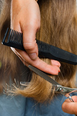 trimming hair with scissors