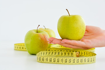Apple and measuring tape suggesting diet concept