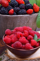 Raspberry, strawberry and blackberry in a wooden basket