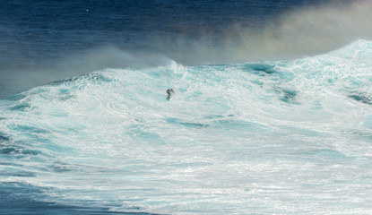 MAUI, HAWAII, USA - DECEMBER 15, 2013: Unknown surfer is riding