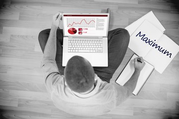 Maximum against young creative businessman working on laptop
