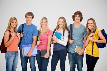 Obraz premium Composite image of smiling students all geared up for college