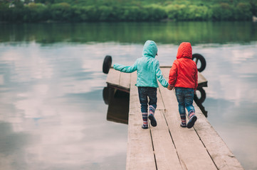 two little sisters, twins are on the Wooden bridge