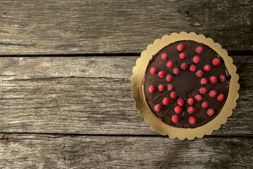Top view of delicious chocolate cake decorated with juicy fresh