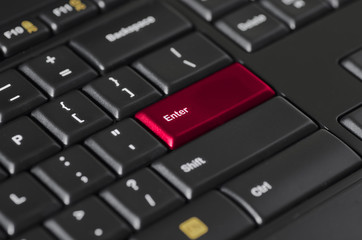 Red enter key on black computer keyboard