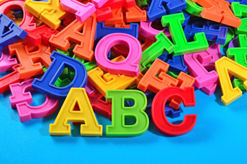 Plastic colored alphabet letters ABC on a blue