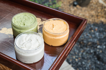Group of cream on wooden tray
