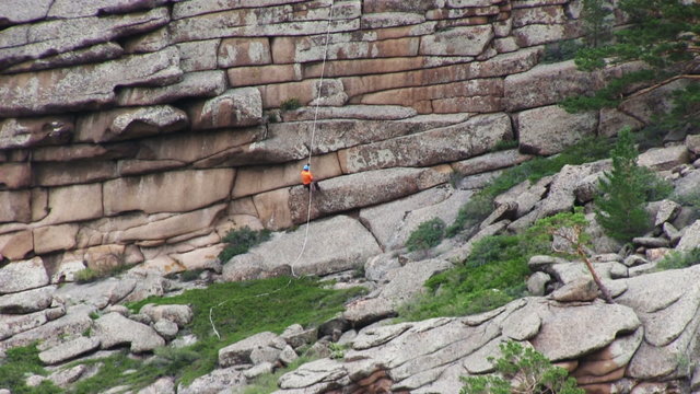 Man Descends From The Top Of The Cliff