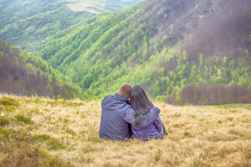 Naklejka na ściany i meble A couple in love against the backdrop of beautiful scenery
