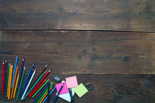 Set of Multicolor Colored Pencils or Crayons on wooden background