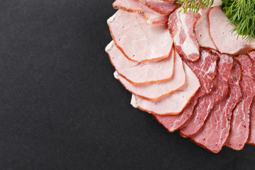 cutting ham with vegetables assortment on black background - 89286345