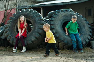 Fototapeta na wymiar children playing in junkyard tires