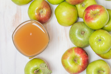 Glass of apple juice and green apples