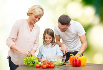 happy family cooking vegetable salad for dinner