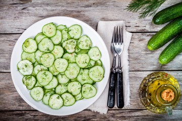 green salad with fresh organic cucumbers and dill with olive oil