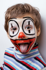 little cute boy with facepaint like clown, pantomimic