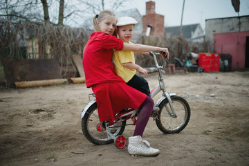 children ride on bicycle in yard