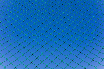 Fototapeta na wymiar Safety nets for ball sports field outdoors blue sky abstract background
