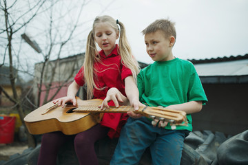 children learn to play the guitar