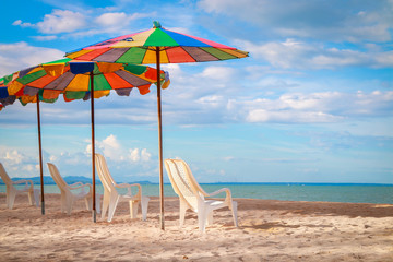 Beach chair and umbrella on sand beach