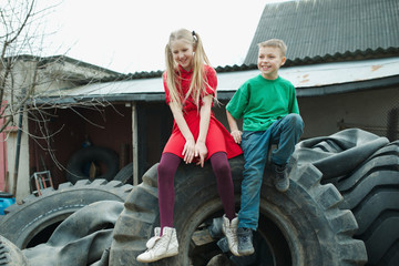 Fototapeta na wymiar children playing in junkyard tires