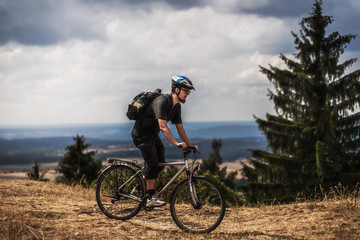 Biking in the Franconian Hills in Northern Bavaria. Young man on