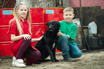 children play at dump with dog