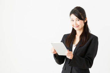 asian businesswoman using tablet computer on white background