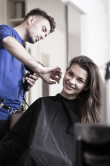 Hairdresser drying woman's hair