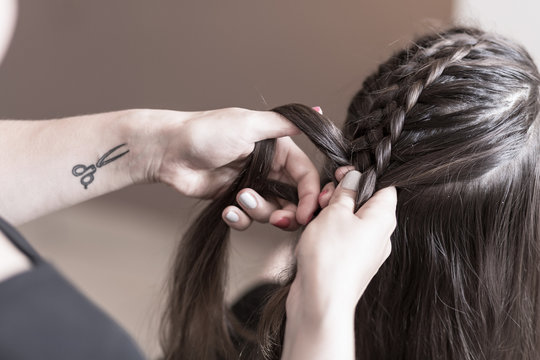 Hairdresser making a braid